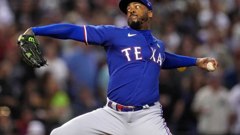 Texas Rangers relief pitcher Aroldis Chapman (45) pitches during the seventh inning against the Arizona Diamondbacks during game five of the 2023 World Series at Chase Field.