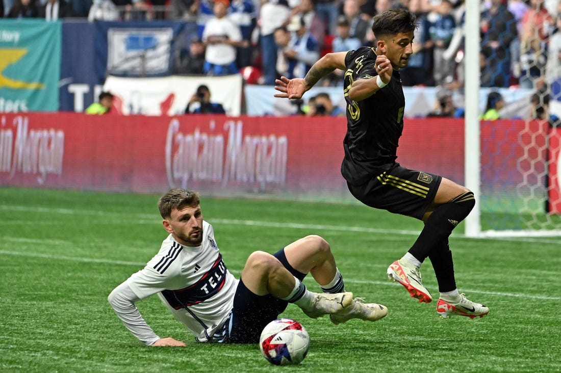 Nov 5, 2023; Vancouver, British Columbia, CAN; Vancouver Whitecaps defender Tristan Blackmon (6) tackles the ball away from Los Angeles FC forward Cristian Olivera (25) during the second half of game two in a round one match of the 2023 MLS Cup Playoffs at BC Place. Mandatory Credit: Simon Fearn-USA TODAY Sports