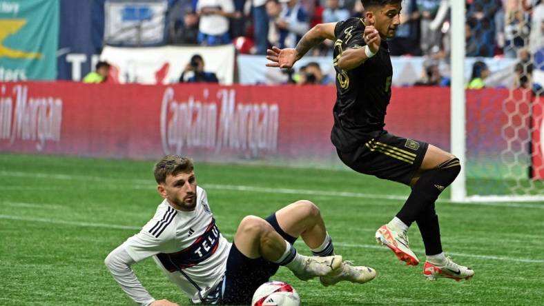 Nov 5, 2023; Vancouver, British Columbia, CAN; Vancouver Whitecaps defender Tristan Blackmon (6) tackles the ball away from Los Angeles FC forward Cristian Olivera (25) during the second half of game two in a round one match of the 2023 MLS Cup Playoffs at BC Place. Mandatory Credit: Simon Fearn-USA TODAY Sports