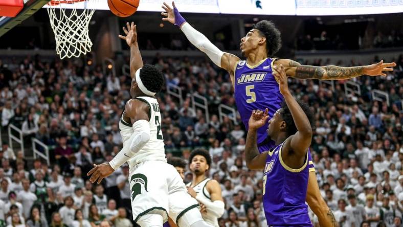 Michigan State's Tyson Walker, left, scores as James Madison's Terrence Edwards, Jr. defends during the second half on Monday, Nov. 6, 2023, in East Lansing.