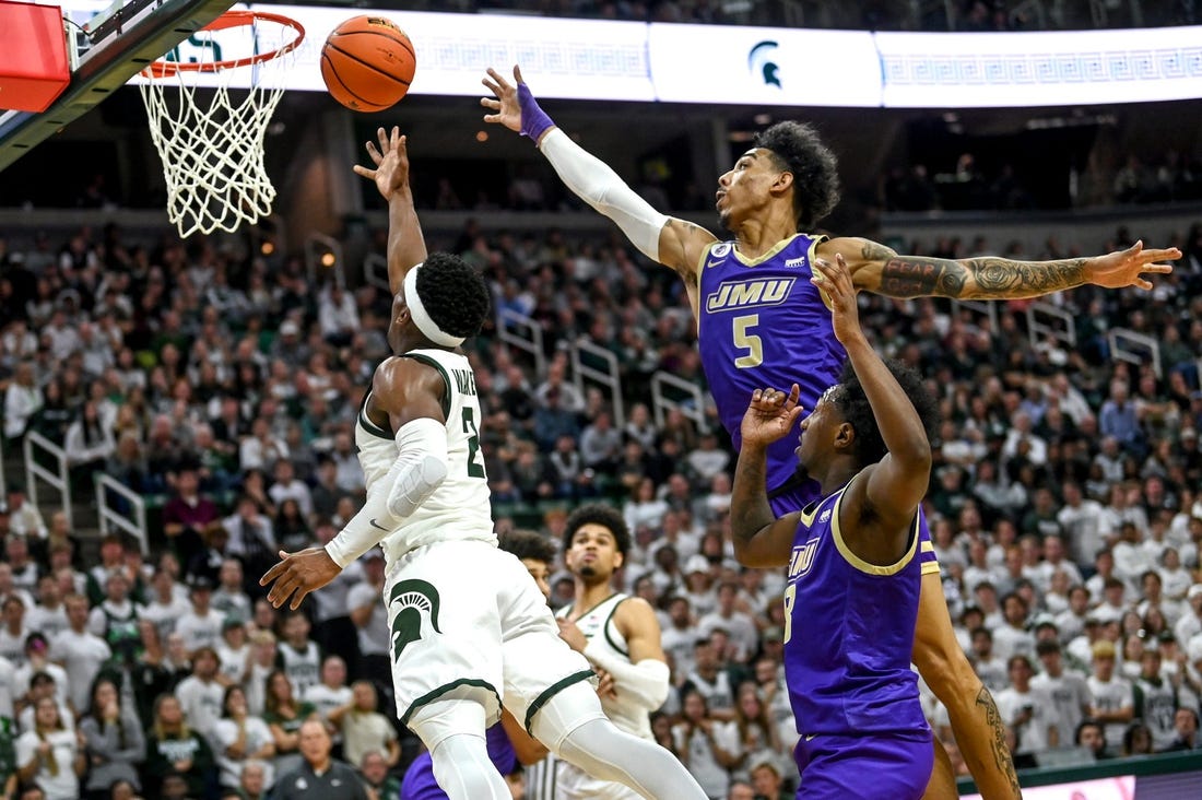 Michigan State's Tyson Walker, left, scores as James Madison's Terrence Edwards, Jr. defends during the second half on Monday, Nov. 6, 2023, in East Lansing.