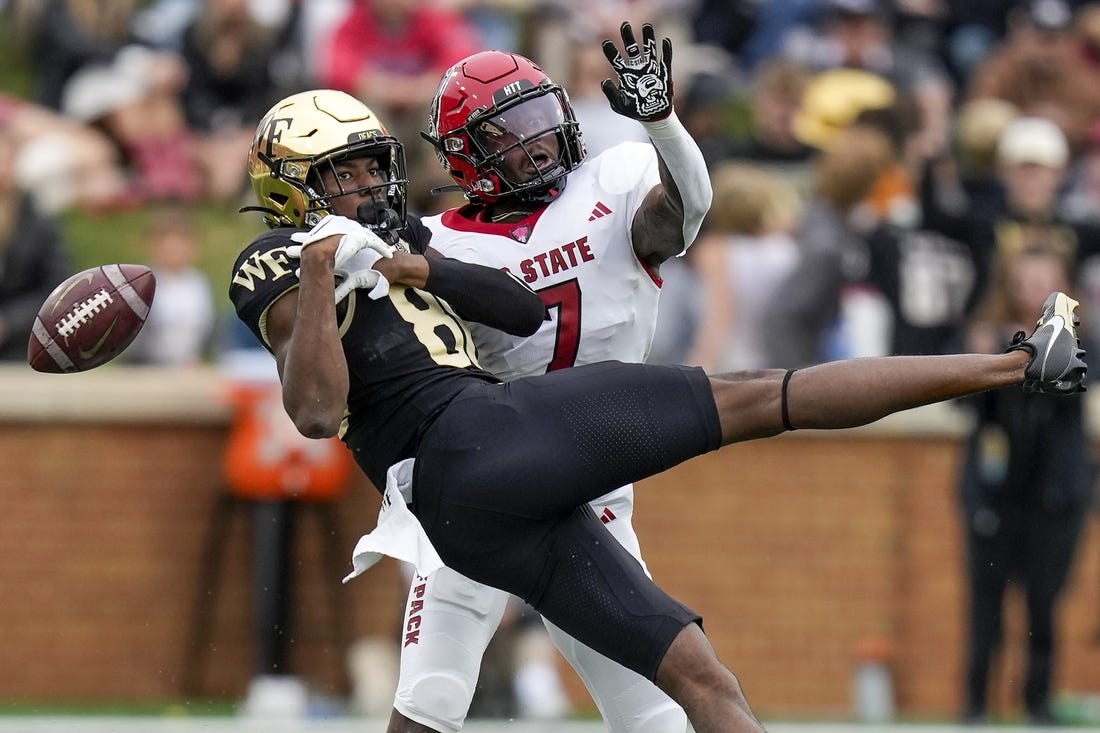 Nov 11, 2023; Winston-Salem, North Carolina, USA; Wake Forest Demon Deacons running back Justice Ellison (6) loses the ball defended by North Carolina State Wolfpack cornerback Shyheim Battle (7) during the first half at Allegacy Federal Credit Union Stadium. Mandatory Credit: Jim Dedmon-USA TODAY Sports