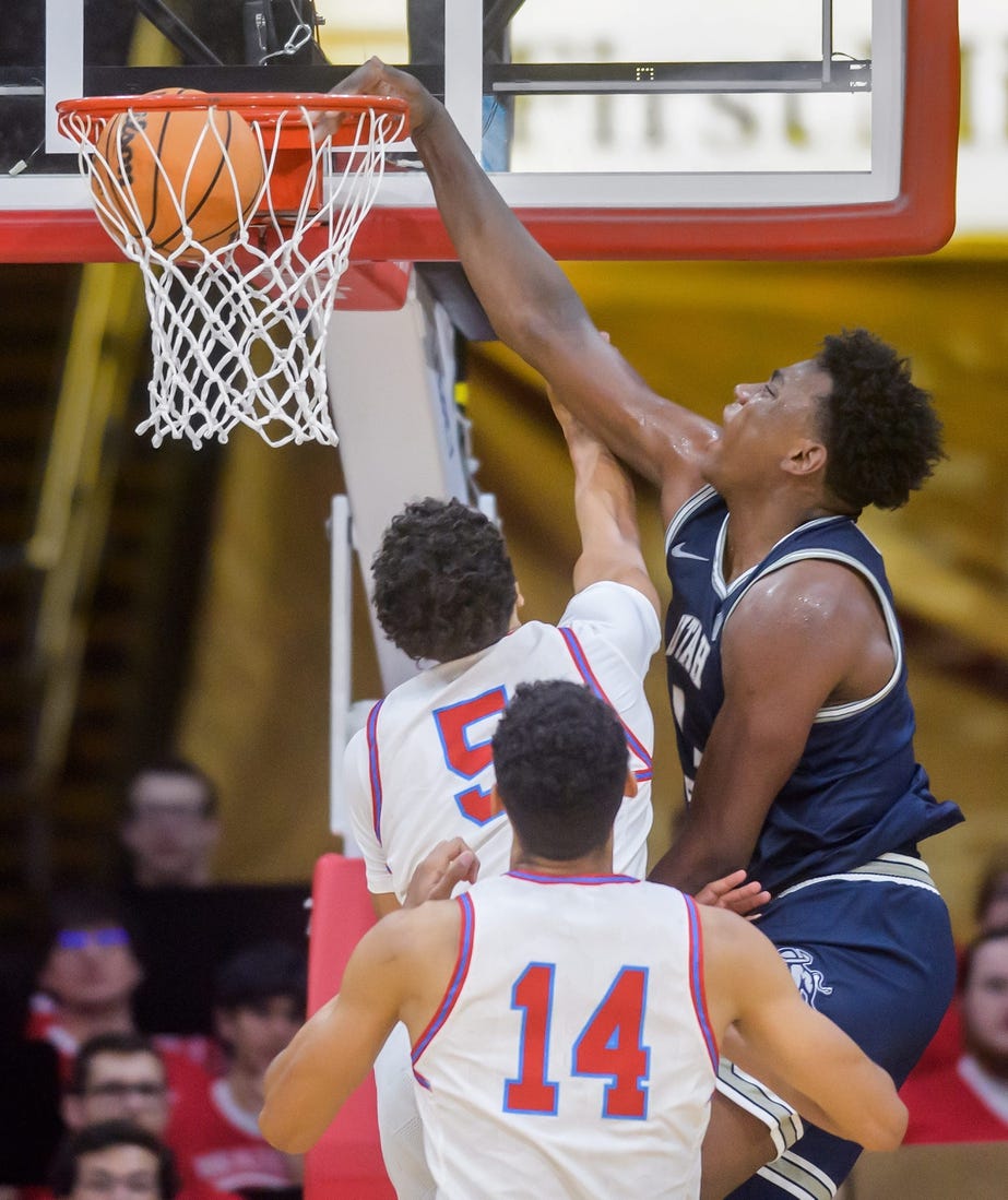 Utah State's Great Osobor, right, slam dunks over Bradley's Christian Davis in the second half of the Braves' home opener Saturday, Nov. 11, 2023 at Carver Arena.