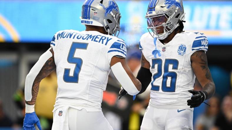 Detroit Lions running back Jahmyr Gibbs (26) celebrates with running back David Montgomery (5) after scoring a touchdown against the Los Angeles Chargers during the first half at SoFi Stadium. Mandatory Credit: Orlando Ramirez-USA TODAY Sports