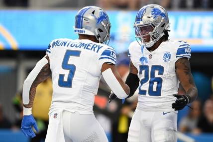 Detroit Lions running back Jahmyr Gibbs (26) celebrates with running back David Montgomery (5) after scoring a touchdown against the Los Angeles Chargers during the first half at SoFi Stadium. Mandatory Credit: Orlando Ramirez-USA TODAY Sports
