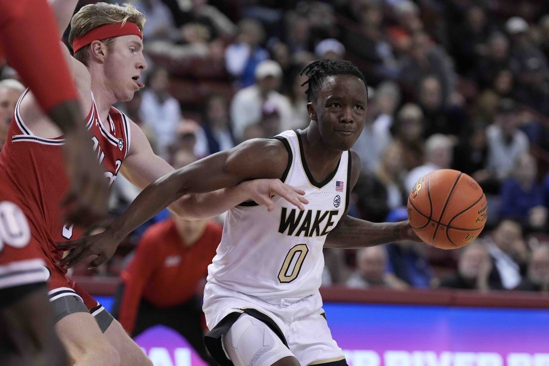 Nov 16, 2023; Charleston, South Carolina, USA; Wake Forest Demon Deacons guard Kevin Miller (0) drives the ball against the Utah Utes in the first half at TD Arena. Mandatory Credit: David Yeazell-USA TODAY Sports