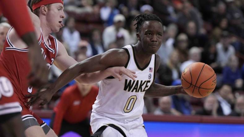 Nov 16, 2023; Charleston, South Carolina, USA; Wake Forest Demon Deacons guard Kevin Miller (0) drives the ball against the Utah Utes in the first half at TD Arena. Mandatory Credit: David Yeazell-USA TODAY Sports