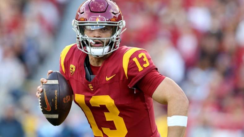 Nov 18, 2023; Los Angeles, California, USA; USC Trojans quarterback Caleb Williams (13) scrambles during the second quarter against the UCLA Bruins at United Airlines Field at Los Angeles Memorial Coliseum. Mandatory Credit: Jason Parkhurst-USA TODAY Sports