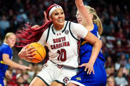 Nov 20, 2023; Columbia, South Carolina, USA; South Carolina Gamecocks center Kamilla Cardoso (10) drives around South Dakota State Jackrabbits forward Brooklyn Meyer (31) in the first half at Colonial Life Arena. Mandatory Credit: Jeff Blake-USA TODAY Sports