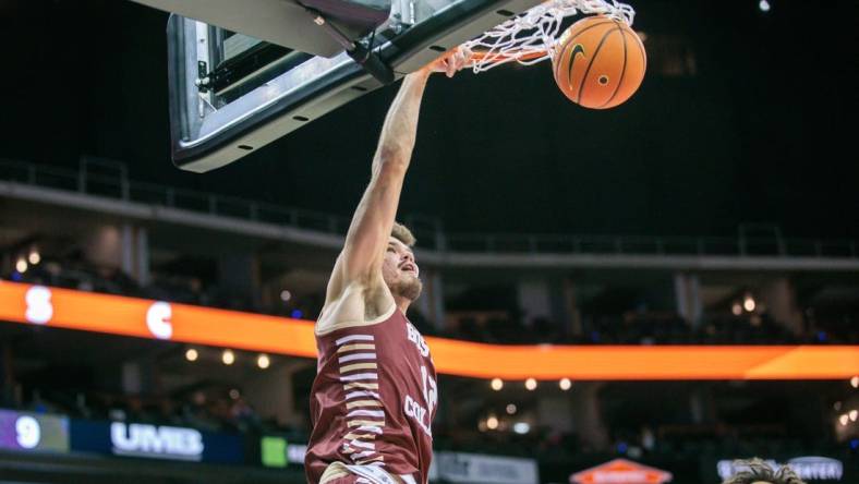 Nov 23, 2023; Kansas City, Missouri, USA; Boston College Eagles forward Quinten Post (12) dunks during the first half against the Loyola (Il) Ramblers at T-Mobile Center. Mandatory Credit: William Purnell-USA TODAY Sports