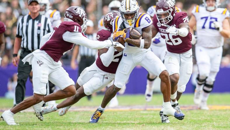 Malik Nabers 8 fights for extra yards as the LSU Tigers take on Texas A&M in Tiger Stadium in Baton Rouge, Louisiana, November 25, 2023.