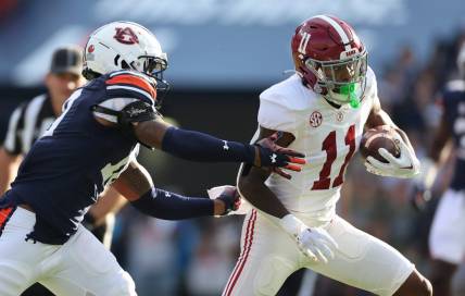 Nov 25, 2023; Auburn, Alabama, USA;  Auburn Tigers safety Zion Puckett (10) closes in on Alabama Crimson Tide wide receiver Malik Benson (11) during the first quarter at Jordan-Hare Stadium. Mandatory Credit: John Reed-USA TODAY Sports