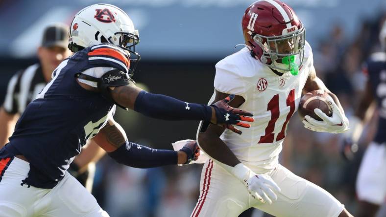 Nov 25, 2023; Auburn, Alabama, USA;  Auburn Tigers safety Zion Puckett (10) closes in on Alabama Crimson Tide wide receiver Malik Benson (11) during the first quarter at Jordan-Hare Stadium. Mandatory Credit: John Reed-USA TODAY Sports