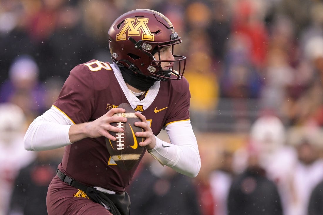 Nov 25, 2023; Minneapolis, Minnesota, USA;  Minnesota Golden Gophers quarterback Athan Kaliakmanis (8) scrambles out of the pocket against the Wisconsin Badgers during the second quarter at Huntington Bank Stadium. Mandatory Credit: Nick Wosika-USA TODAY Sports