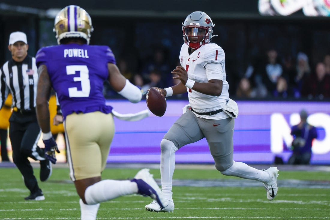 Nov 25, 2023; Seattle, Washington, USA; Washington State Cougars quarterback Cameron Ward (1) scrambles out of the pocket against the Washington Huskies during the second quarter at Alaska Airlines Field at Husky Stadium. Mandatory Credit: Joe Nicholson-USA TODAY Sports