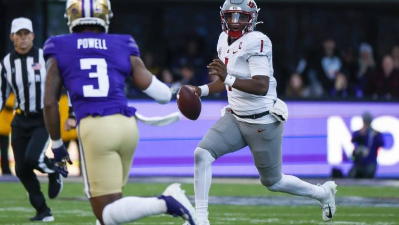 Nov 25, 2023; Seattle, Washington, USA; Washington State Cougars quarterback Cameron Ward (1) scrambles out of the pocket against the Washington Huskies during the second quarter at Alaska Airlines Field at Husky Stadium. Mandatory Credit: Joe Nicholson-USA TODAY Sports