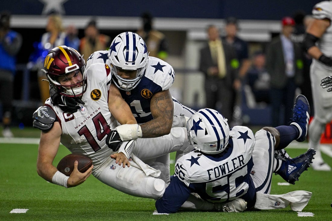 Nov 23, 2023; Arlington, Texas, USA; Dallas Cowboys linebacker Micah Parsons (11) and defensive end Dante Fowler Jr. (56) and Washington Commanders quarterback Sam Howell (14) in action during the game between the Dallas Cowboys and the Washington Commanders at AT&T Stadium. Mandatory Credit: Jerome Miron-USA TODAY Sports