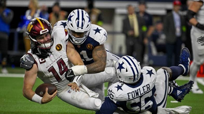 Nov 23, 2023; Arlington, Texas, USA; Dallas Cowboys linebacker Micah Parsons (11) and defensive end Dante Fowler Jr. (56) and Washington Commanders quarterback Sam Howell (14) in action during the game between the Dallas Cowboys and the Washington Commanders at AT&T Stadium. Mandatory Credit: Jerome Miron-USA TODAY Sports