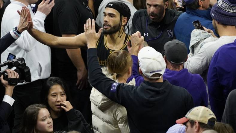 Dec 1, 2023; Evanston, Illinois, USA; Northwestern Wildcats guard Boo Buie (0) celebrates Northwestern   s overtime win against the Purdue Boilermakers at Welsh-Ryan Arena. Mandatory Credit: David Banks-USA TODAY Sports