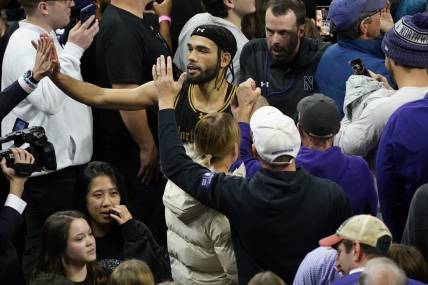 Dec 1, 2023; Evanston, Illinois, USA; Northwestern Wildcats guard Boo Buie (0) celebrates Northwestern   s overtime win against the Purdue Boilermakers at Welsh-Ryan Arena. Mandatory Credit: David Banks-USA TODAY Sports