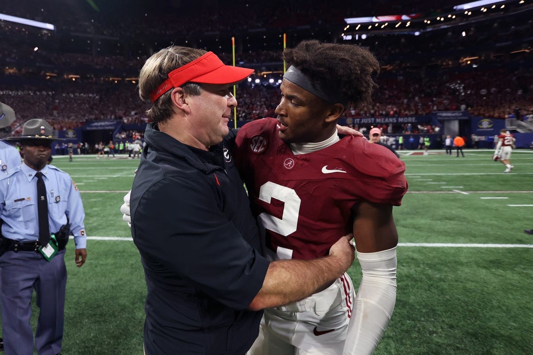 Dec 2, 2023; Atlanta, GA, USA;  Georgia Bulldogs head coach Kirby Smart embraces Alabama Crimson Tide defensive back Caleb Downs (2) after the SEC championship game at Mercedes-Benz Stadium. Mandatory Credit: Brett Davis-USA TODAY Sports