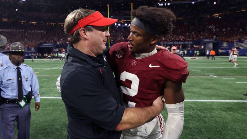 Dec 2, 2023; Atlanta, GA, USA;  Georgia Bulldogs head coach Kirby Smart embraces Alabama Crimson Tide defensive back Caleb Downs (2) after the SEC championship game at Mercedes-Benz Stadium. Mandatory Credit: Brett Davis-USA TODAY Sports