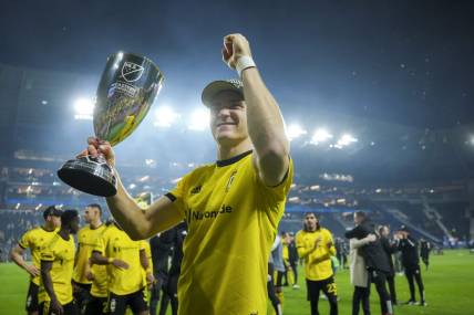 Dec 2, 2023; Cincinnati, Ohio, USA;  Columbus Crew defender Julian Gressel (7) celebrates with the trophy after defeating FC Cincinnati at TQL Stadium. Mandatory Credit: Aaron Doster-USA TODAY Sports