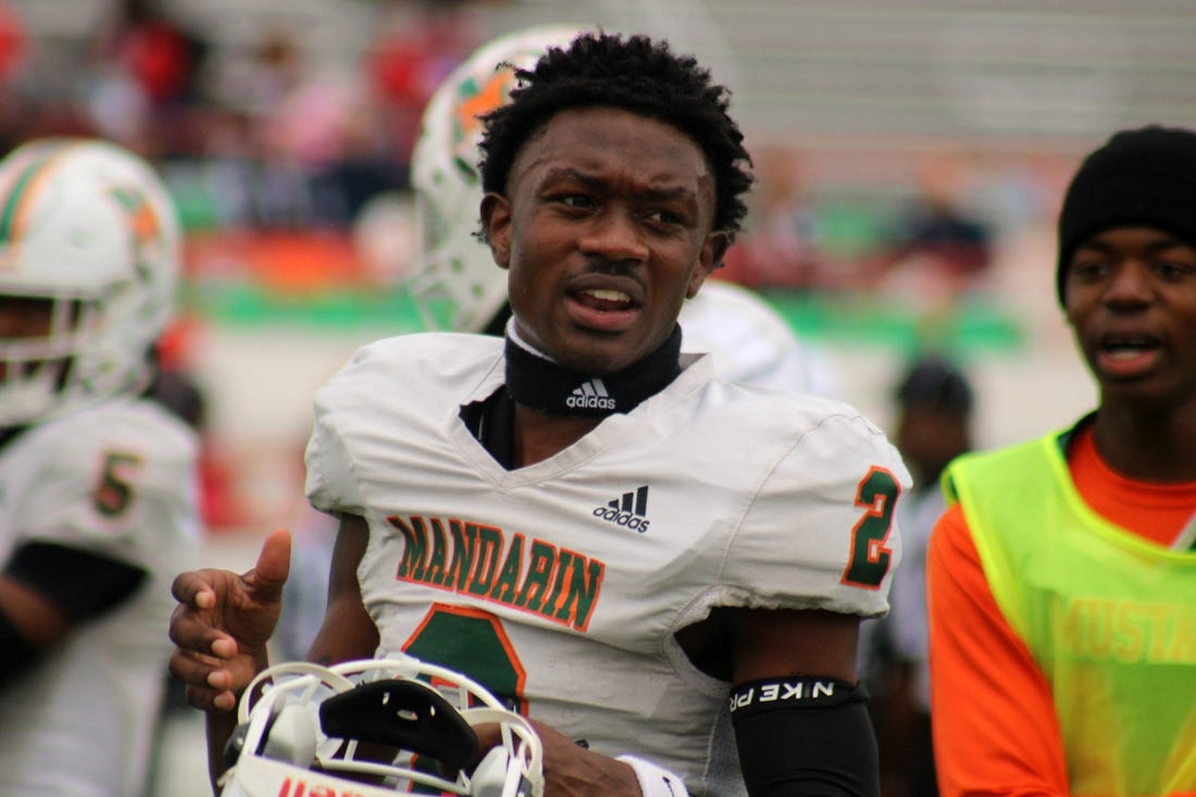 Mandarin wide receiver Jaime Ffrench Jr. (2) talks with teammates on the sideline before the FHSAA Class 4M high school football championship game against Miami Columbus on December 8, 2023. [Clayton Freeman/Florida Times-Union]