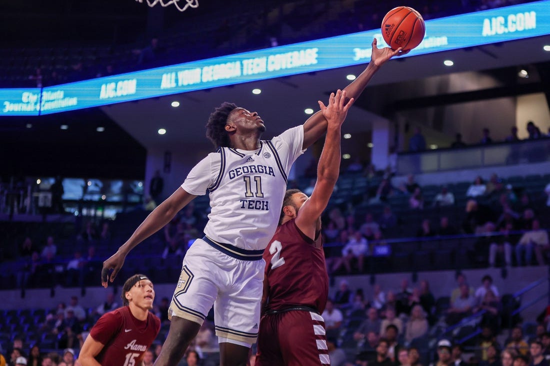 Dec 9, 2023; Atlanta, Georgia, USA; Georgia Tech Yellow Jackets forward Baye Ndongo (11) reaches for a rebound over Alabama A&M Bulldogs guard Omari Peek (2) in the first half at McCamish Pavilion. Mandatory Credit: Brett Davis-USA TODAY Sports