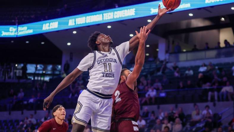 Dec 9, 2023; Atlanta, Georgia, USA; Georgia Tech Yellow Jackets forward Baye Ndongo (11) reaches for a rebound over Alabama A&M Bulldogs guard Omari Peek (2) in the first half at McCamish Pavilion. Mandatory Credit: Brett Davis-USA TODAY Sports