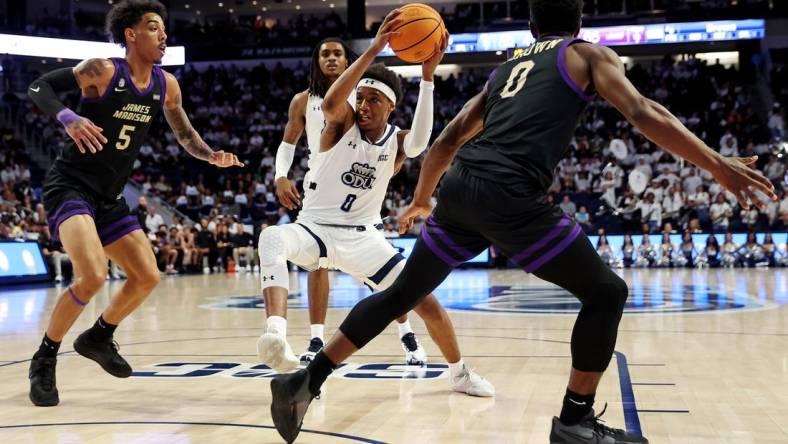 Dec 9, 2023; Norfolk, Virginia, USA; Old Dominion Monarchs guard Vasean Allette (0) drives to the basket against James Madison Dukes guard Terrence Edwards (5) and guard Xavier Brown (0) during the second half at Chartway Arena at the Ted Constant Convocation Center. Mandatory Credit: Peter Casey-USA TODAY Sports