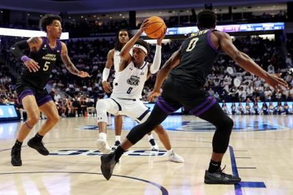 Dec 9, 2023; Norfolk, Virginia, USA; Old Dominion Monarchs guard Vasean Allette (0) drives to the basket against James Madison Dukes guard Terrence Edwards (5) and guard Xavier Brown (0) during the second half at Chartway Arena at the Ted Constant Convocation Center. Mandatory Credit: Peter Casey-USA TODAY Sports