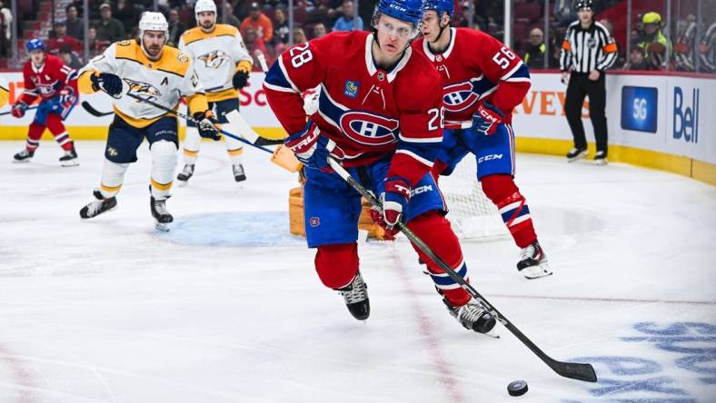 Dec 10, 2023; Montreal, Quebec, CAN; Montreal Canadiens center Christian Dvorak (28) plays the puck against the Nashville Predators during the first period at Bell Centre. Mandatory Credit: David Kirouac-USA TODAY Sports