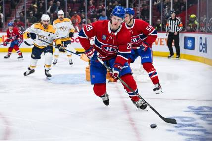 Dec 10, 2023; Montreal, Quebec, CAN; Montreal Canadiens center Christian Dvorak (28) plays the puck against the Nashville Predators during the first period at Bell Centre. Mandatory Credit: David Kirouac-USA TODAY Sports