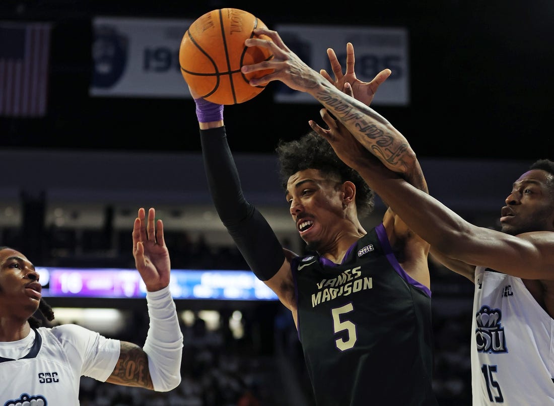 Dec 9, 2023; Norfolk, Virginia, USA; James Madison Dukes guard Terrence Edwards (5) drives to the basket against Old Dominion Monarchs guard Chaunce Jenkins (2) guard R.J. Blakney (15) at Chartway Arena at the Ted Constant Convocation Center. Mandatory Credit: Peter Casey-USA TODAY Sports
