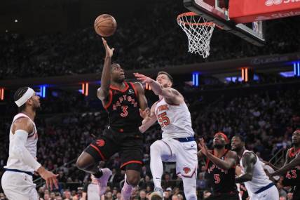 Dec 11, 2023; New York, New York, USA; Toronto Raptors forward O.G. Anunoby (3) shoots the ball while being defended by New York Knicks center Isaiah Hartenstein (55) during the fourth quarter at Madison Square Garden. Mandatory Credit: John Jones-USA TODAY Sports
