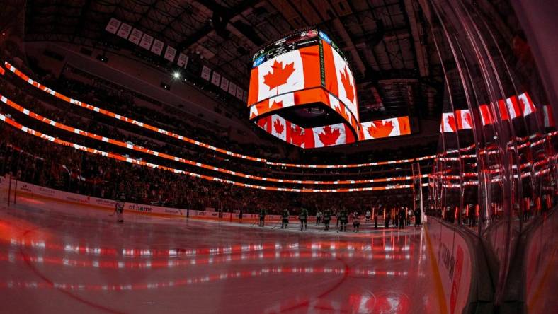 Dec 15, 2023; Dallas, Texas, USA; A view of the Canadian flag during the playing of the national anthem of Canada before the game between the Dallas Stars and the Ottawa Senators at the American Airlines Center. Mandatory Credit: Jerome Miron-USA TODAY Sports