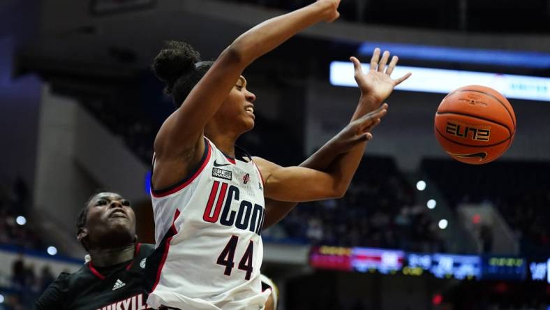 Dec 16, 2023; Hartford, Connecticut, USA; UConn Huskies guard Aubrey Griffin (44) is fouled by Louisville Cardinals forward Olivia Cochran (44) in the second half at XL Center. Mandatory Credit: David Butler II-USA TODAY Sports