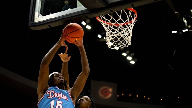 Dayton Flyers forward DaRon Holmes II (15) draws a foul from Cincinnati Bearcats guard Day Day Thomas (1) in the second half of the NCAA men's basketball game between the Dayton Flyers and Cincinnati Bearcats at Heritage Bank Center in Cincinnati on Saturday, Dec. 16, 2023.