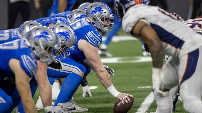 Dec 16, 2023; Detroit, Michigan, USA; Detroit Lions center Frank Ragnow (77) gets ready to snap the ball in the first half against the Denver Broncos at Ford Field. Mandatory Credit: David Reginek-USA TODAY Sports