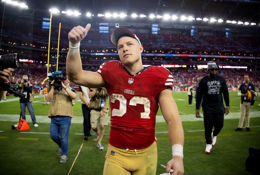 Dec 17, 2023; Glendale, Arizona, USA; San Francisco 49ers running back Christian McCaffrey (23) celebrates after beating the Arizona Cardinals at State Farm Stadium. Mandatory Credit: Mark J. Rebilas-USA TODAY Sports