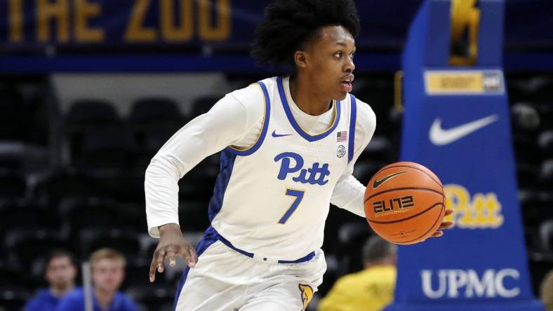 Dec 20, 2023; Pittsburgh, Pennsylvania, USA; Pittsburgh Panthers guard Carlton Carrington (7) dribbles up court on a fast break against the IPFW Mastodons during the first half at the Petersen Events Center. Mandatory Credit: Charles LeClaire-USA TODAY Sports