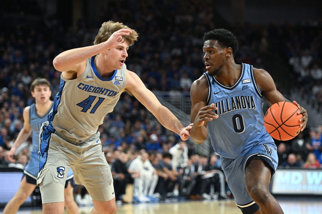 Dec 20, 2023; Omaha, Nebraska, USA;  Villanova Wildcats guard TJ Bamba (0) drives against Creighton Bluejays forward Isaac Traudt (41) in the first half at CHI Health Center Omaha. Mandatory Credit: Steven Branscombe-USA TODAY Sports