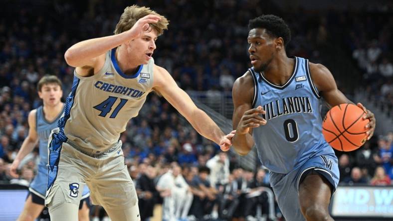 Dec 20, 2023; Omaha, Nebraska, USA;  Villanova Wildcats guard TJ Bamba (0) drives against Creighton Bluejays forward Isaac Traudt (41) in the first half at CHI Health Center Omaha. Mandatory Credit: Steven Branscombe-USA TODAY Sports