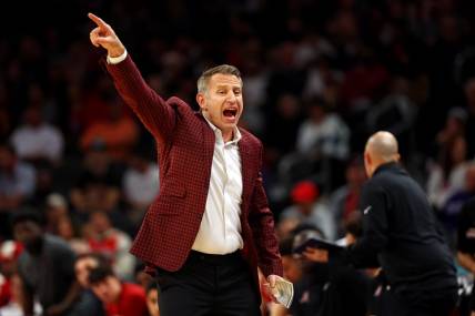 Dec 20, 2023; Phoenix, Arizona, USA; Alabama Crimson Tide head coach Nate Oats signals to his team during the first half of the game against the Arizona Wildcats in the Hall of Fame Series at Footprint Center. Mandatory Credit: Mark J. Rebilas-USA TODAY Sports