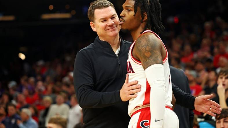 Dec 20, 2023; Phoenix, Arizona, USA; Arizona Wildcats head coach Tommy Lloyd talks to guard Caleb Love (2) during the second half of the game against the Alabama Crimson Tide in the Hall of Fame Series at Footprint Center. Mandatory Credit: Mark J. Rebilas-USA TODAY Sports