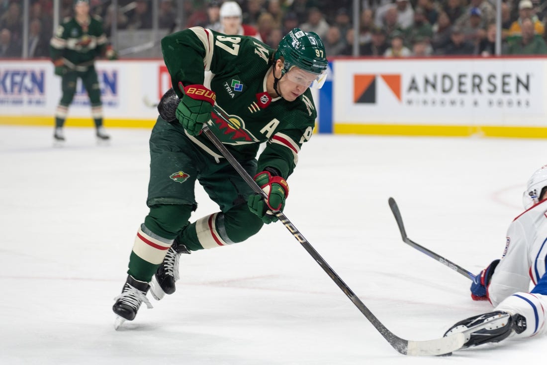 Dec 21, 2023; Saint Paul, Minnesota, USA; Minnesota Wild left wing Kirill Kaprizov (97) skates around a Montreal Canadiens player in the first period at Xcel Energy Center. Mandatory Credit: Matt Blewett-USA TODAY Sports