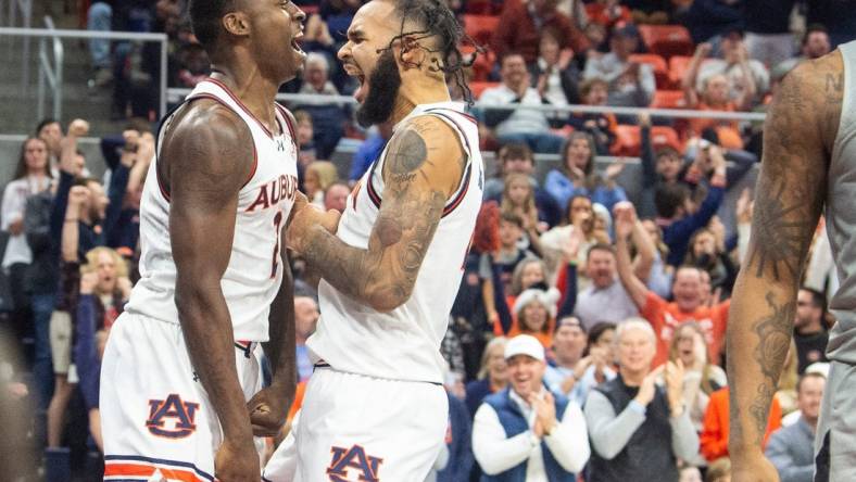 Auburn Tigers forward Jaylin Williams (2) and center Johni Broome (4) celebrate Williams alley-op dunk as Auburn Tigers take on Alabama State Hornets at Neville Arena in Auburn, Ala., on Friday, Dec. 22, 2023. Auburn Tigers defeated Alabama State Hornets 82-62.