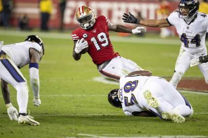 Dec 25, 2023; Santa Clara, California, USA; San Francisco 49ers wide receiver Deebo Samuel (19) is tackled by Baltimore Ravens defensive tackle Michael Pierce (58) during the fourth quarter at Levi's Stadium. Mandatory Credit: Neville E. Guard-USA TODAY Sports