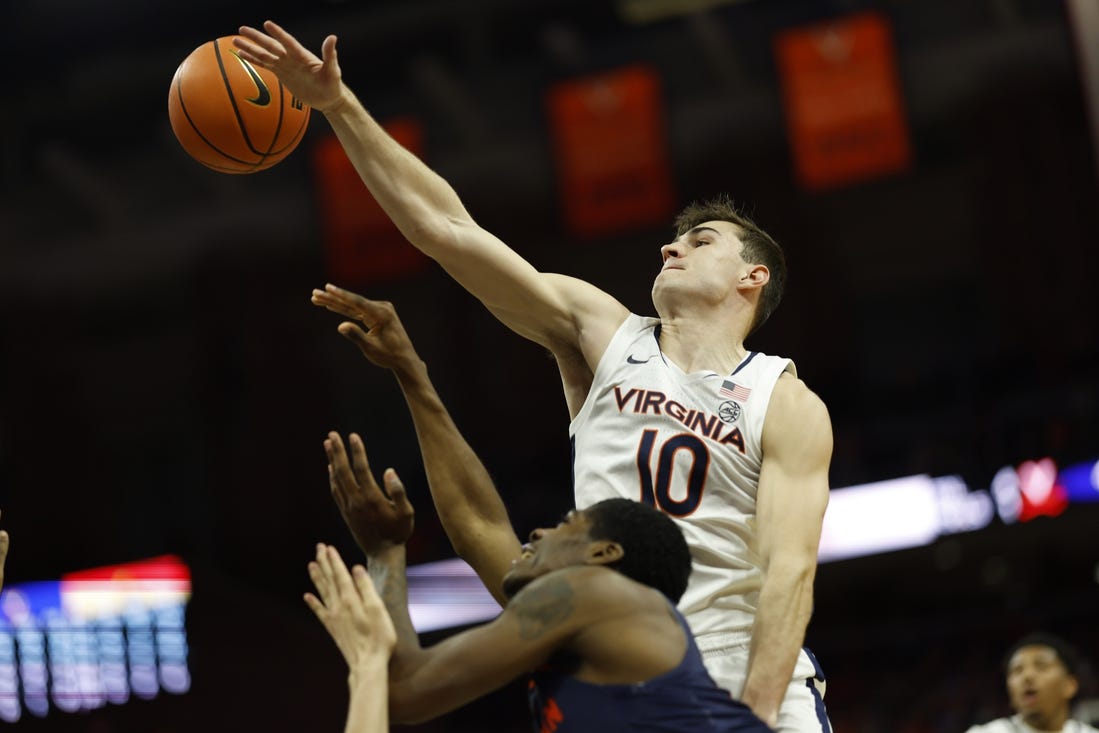 Dec 27, 2023; Charlottesville, Virginia, USA; Virginia Cavaliers guard Taine Murray (10) blocks the shot of Morgan State Bears guard Amahrie Simpkins (11) in the first half at John Paul Jones Arena. Mandatory Credit: Geoff Burke-USA TODAY Sports